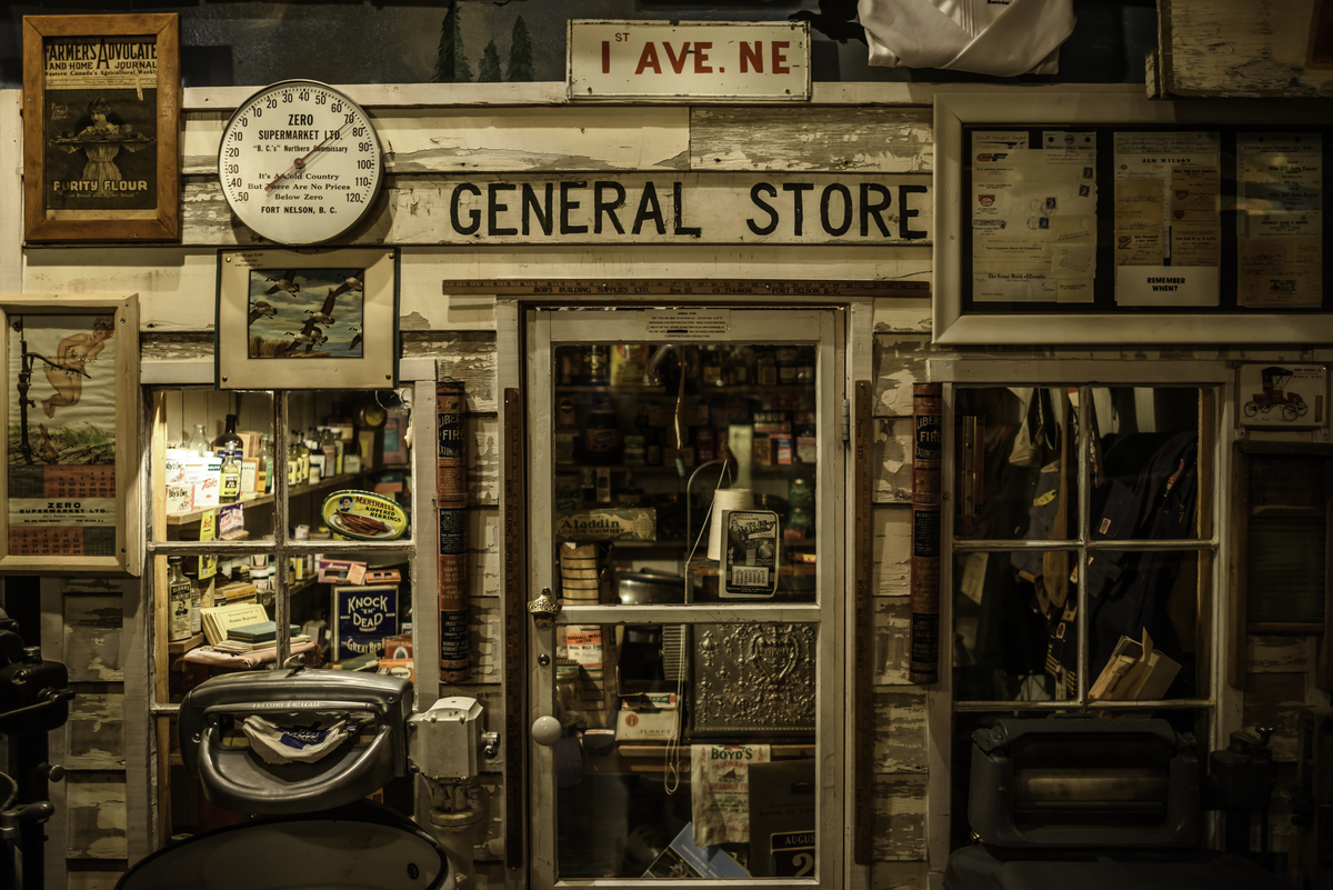 A close-up view of an old, weathered door with a sign above that reads 